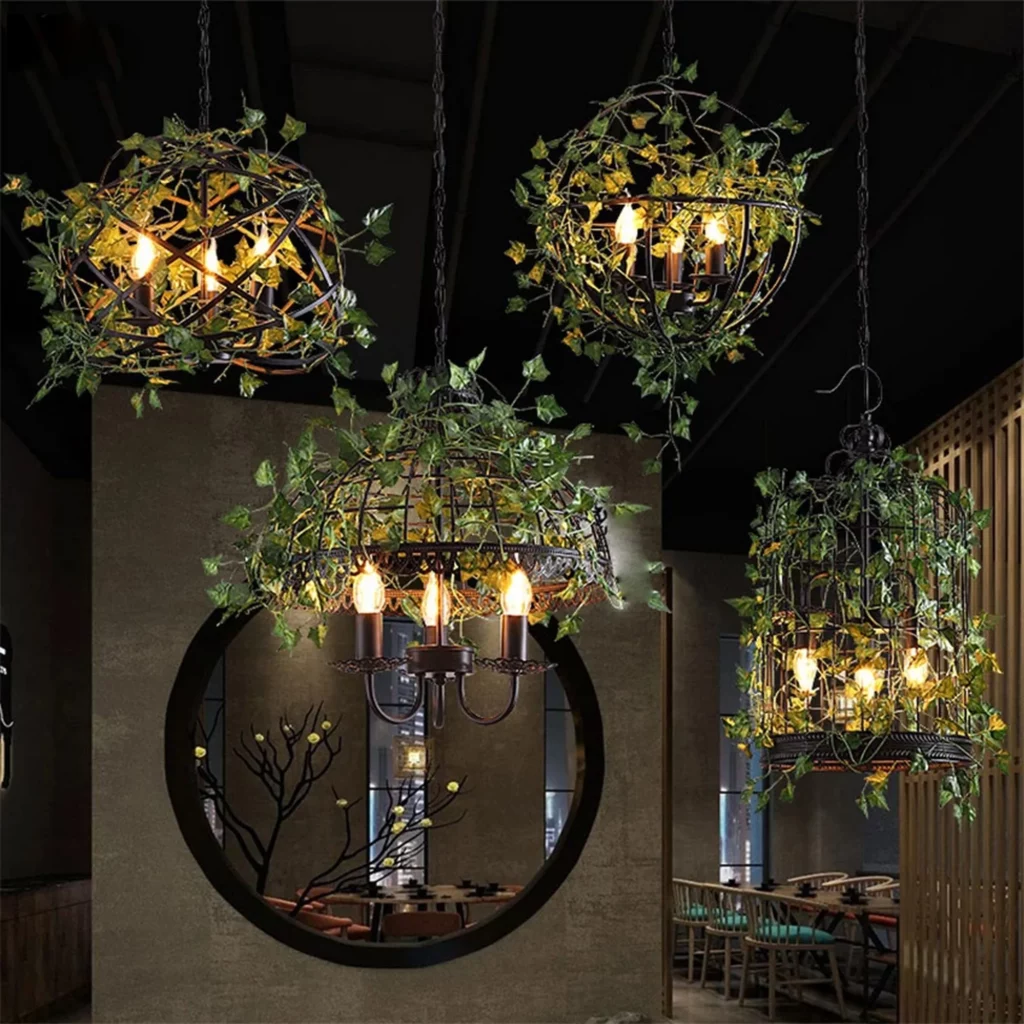 Vintage Style Birdcage Design Plant Chandelier featuring a black metal frame entwined with lush green ivy and warm Edison bulbs.