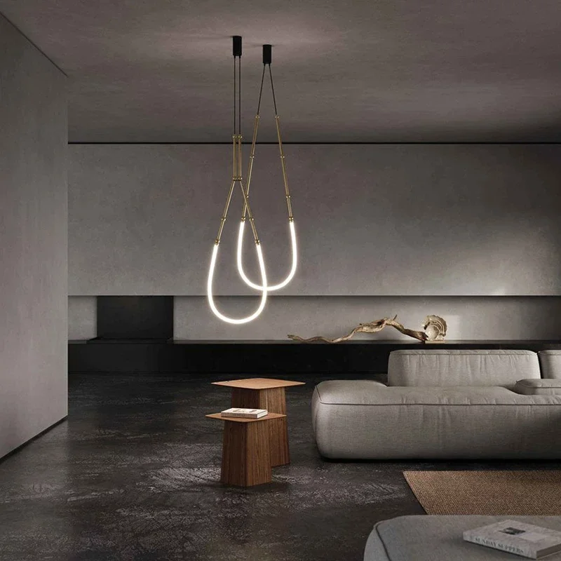 LEDA LED pendant lamp features two glowing, U-shaped minimalist loops suspended in a sleek, dark modern living space.