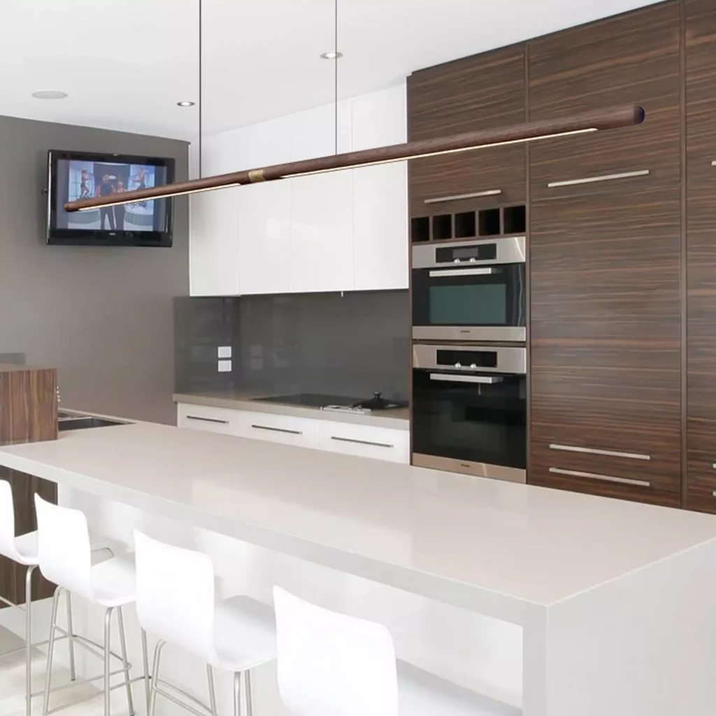 Nordic Long Rod Wooden Chandelier over modern kitchen island with white cabinets and wood paneling, minimalist Nordic design lighting fixture