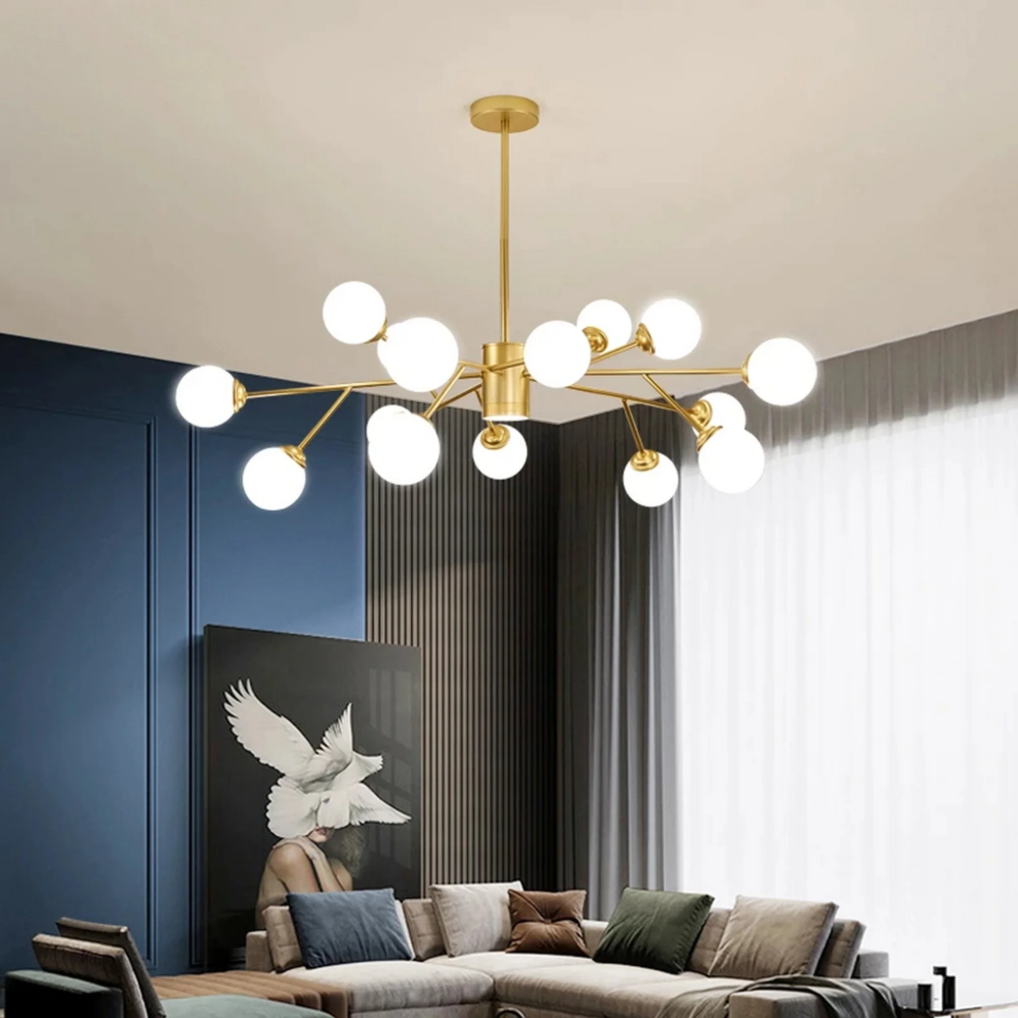 Large contemporary sputnik chandelier with a gold frame and numerous frosted white globe bulbs over a gray sectional sofa.