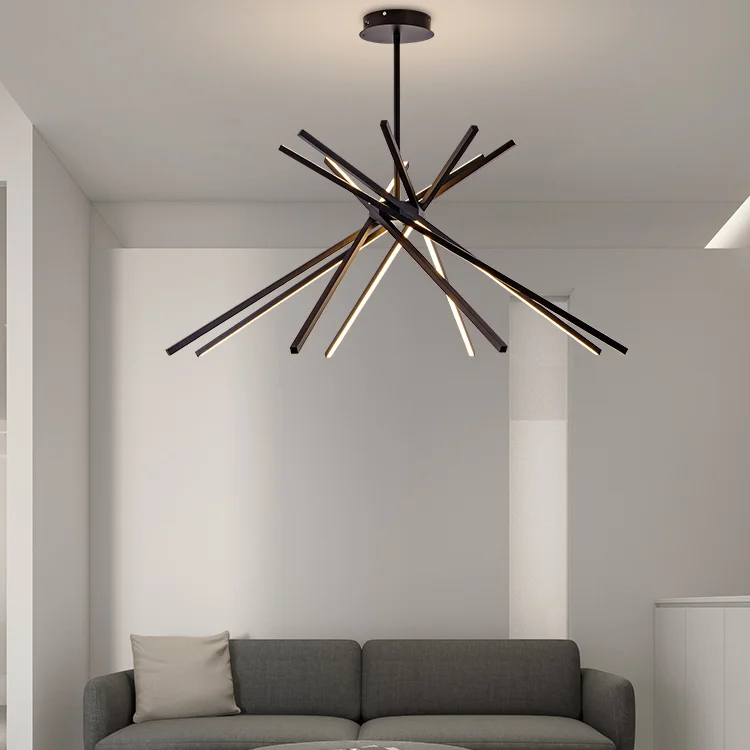 Stripe Design LED Chandelier with intersecting black and warm light bars suspended above a modern gray sofa in a minimalist living room