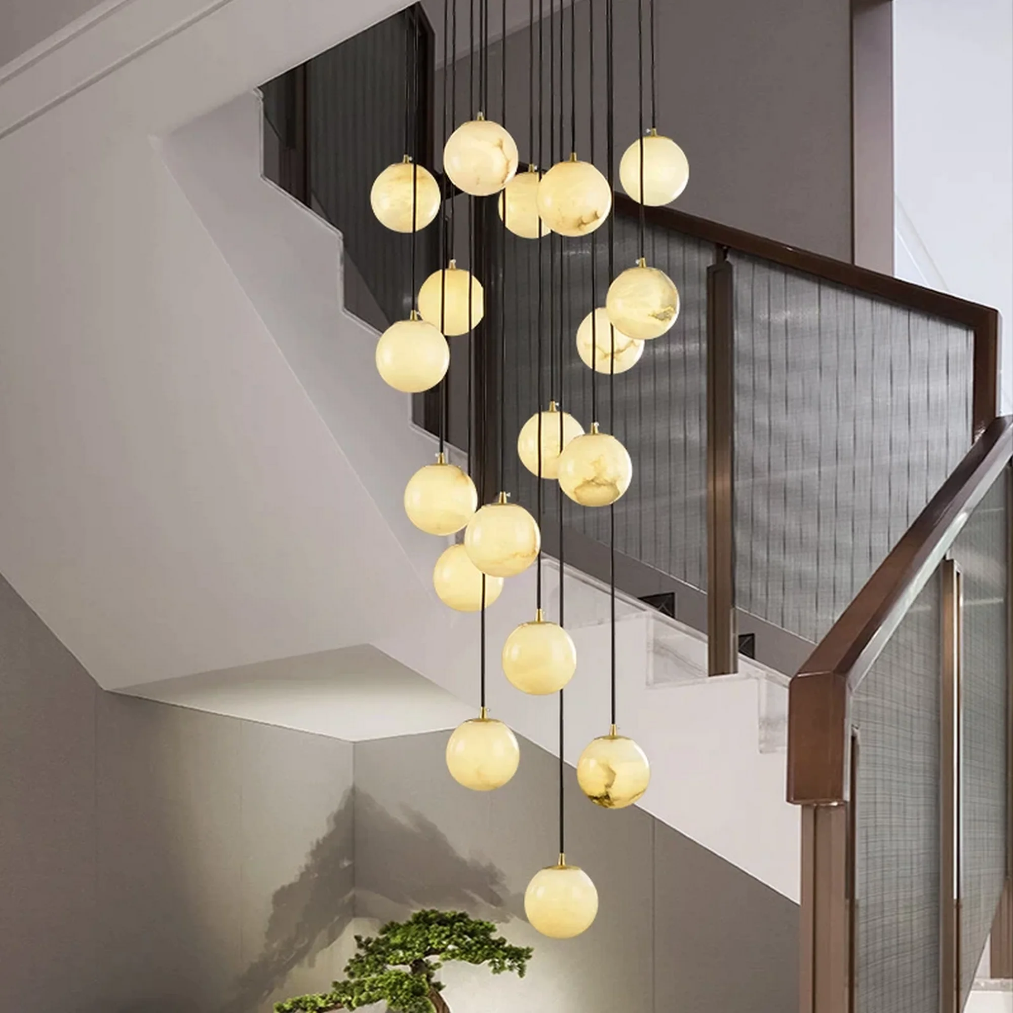 A stunning Luxury Marble Globe Staircase Chandelier with multiple glowing spheres, hanging elegantly above a staircase.