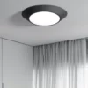 Art Design Geometrical Round Shape Lamp, black modern ceiling light with white diffuser in minimalist room.