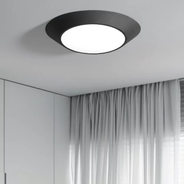 Art Design Geometrical Round Shape Lamp, black modern ceiling light with white diffuser in minimalist room.