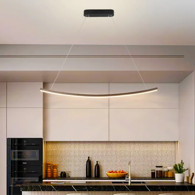 Sleek Black Aluminum LED Dining pendant lamp with a minimalist curved design hanging over a modern kitchen island.