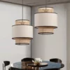 Japanese Style Rattan Woven Pendant Light above a dining table with layered woven and fabric shade design.
