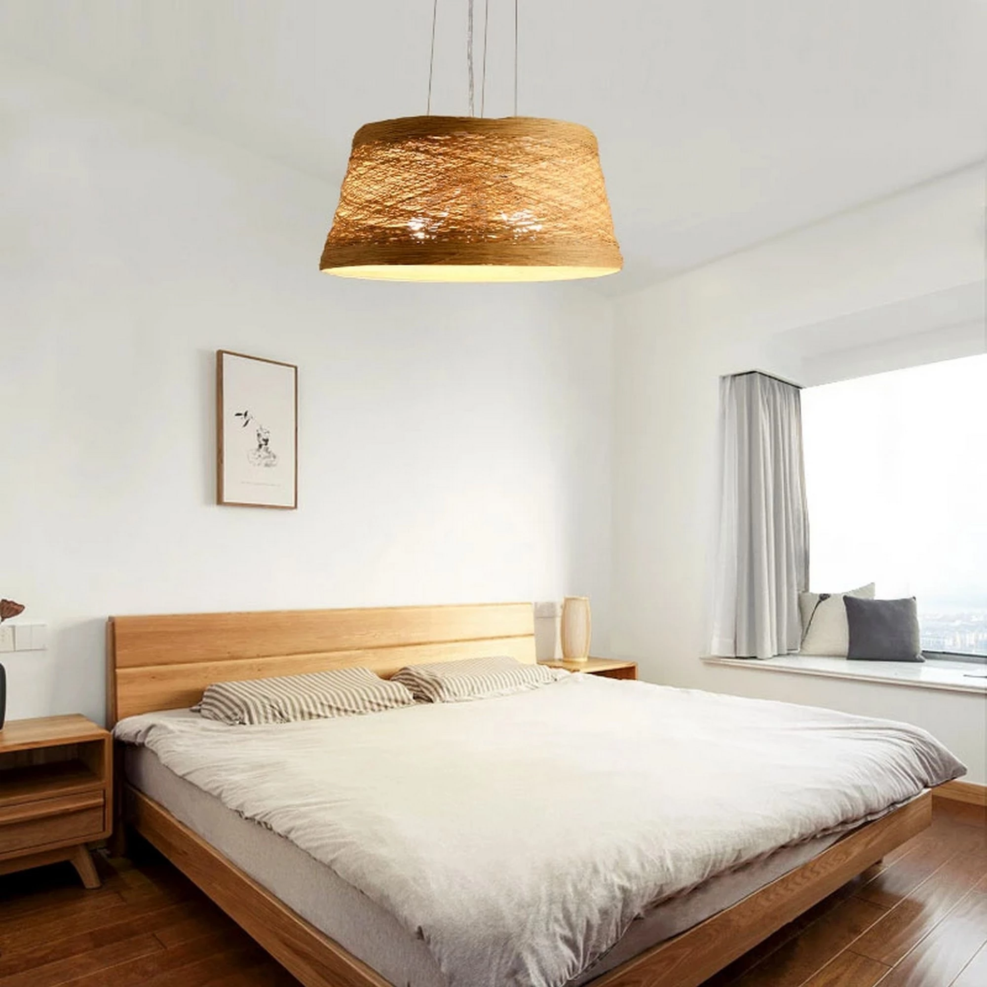 Simple Rattan Wooden Pendant Light above a wooden bed in a bright minimalist bedroom.