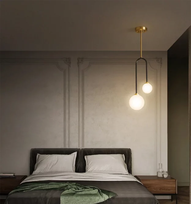 The final image features a Copper Body Bedroom Ceiling Lamp with a minimalist, asymmetrical design. The fixture consists of a slender gold-finished rod and a black U-shaped frame holding two frosted glass globes of different sizes, casting a soft, ambient glow.