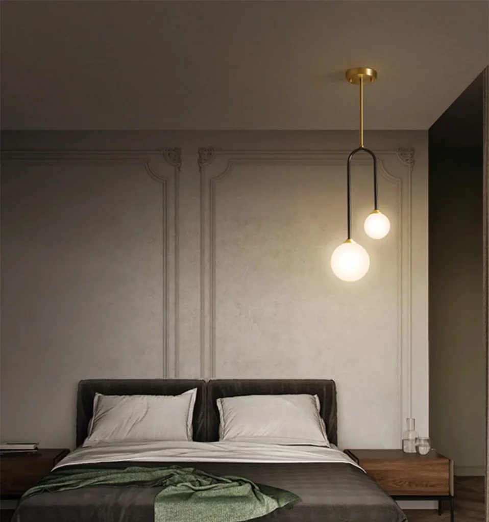 The final image features a Copper Body Bedroom Ceiling Lamp with a minimalist, asymmetrical design. The fixture consists of a slender gold-finished rod and a black U-shaped frame holding two frosted glass globes of different sizes, casting a soft, ambient glow.