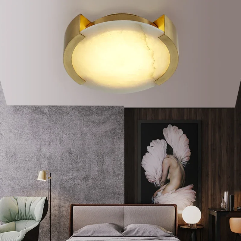 Bedroom interior with Luxury Round Square Marble Ceiling Lamp in gold frame casting warm glow above upholstered bed and artwork