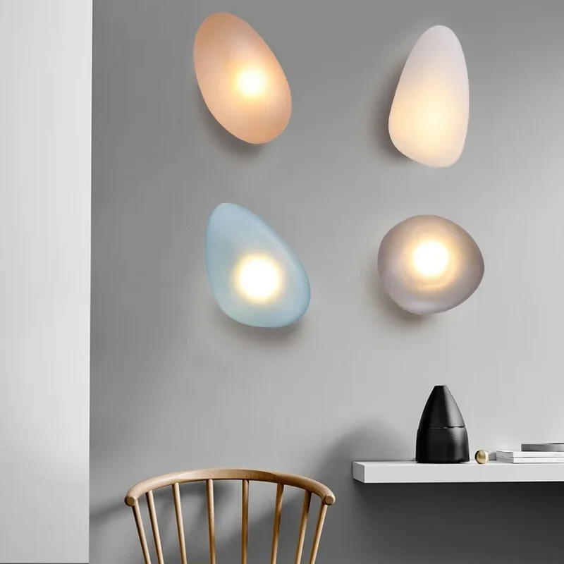 PEBBLE LED Glass Wall Light with smooth pebble-shaped glass shades in soft glowing colors, modern decorative wall lighting.