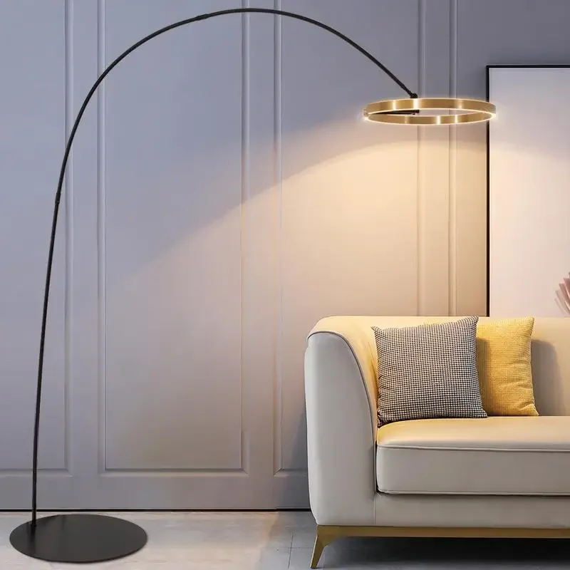 Arx Floor Lamp with an elegant arch design, casting light over a modern sofa in a stylish living room.
