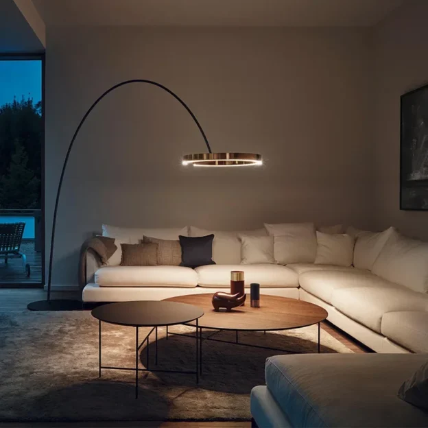 Arx Floor Lamp in a modern living room with an arched LED ring light above a sectional sofa.