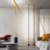 Elastica LED Floor Lamp with vibrant yellow and red poles, brightening up the space.