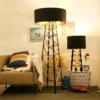 Construction Floor & Table Lamp set featuring black lampshades with a geometric metal base, placed beside a cozy sofa and decor.