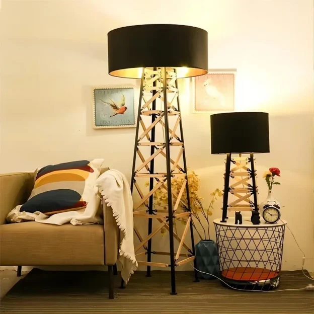 Construction Floor & Table Lamp set featuring black lampshades with a geometric metal base, placed beside a cozy sofa and decor.