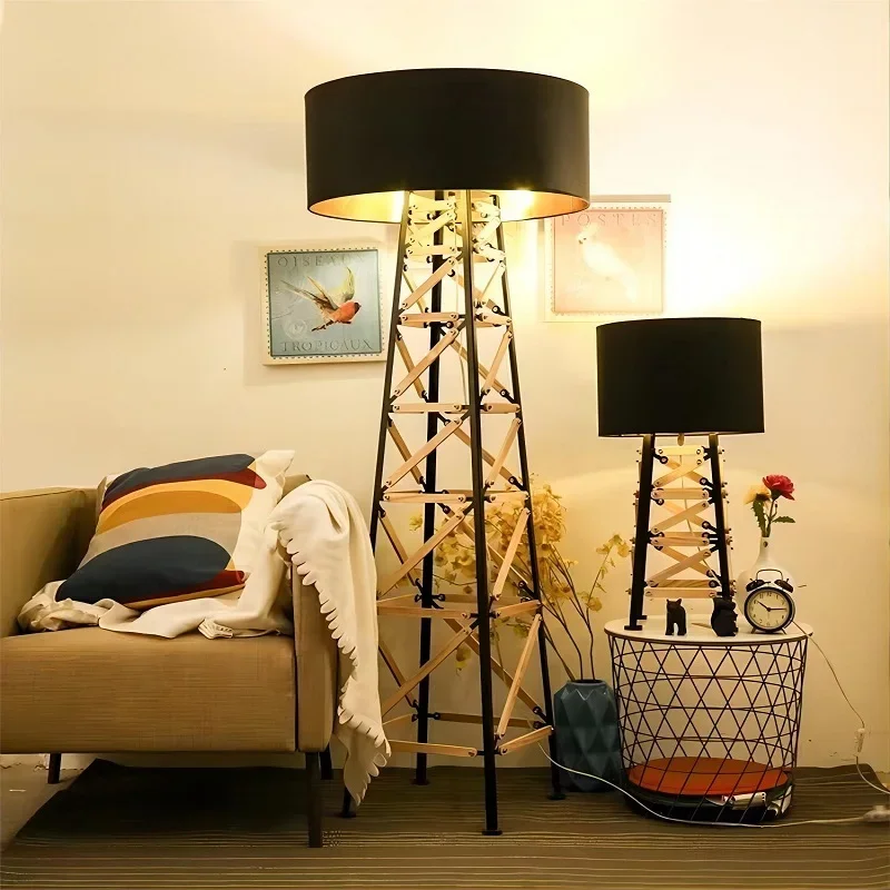 Construction Floor & Table Lamp set featuring black lampshades with a geometric metal base, placed beside a cozy sofa and decor.