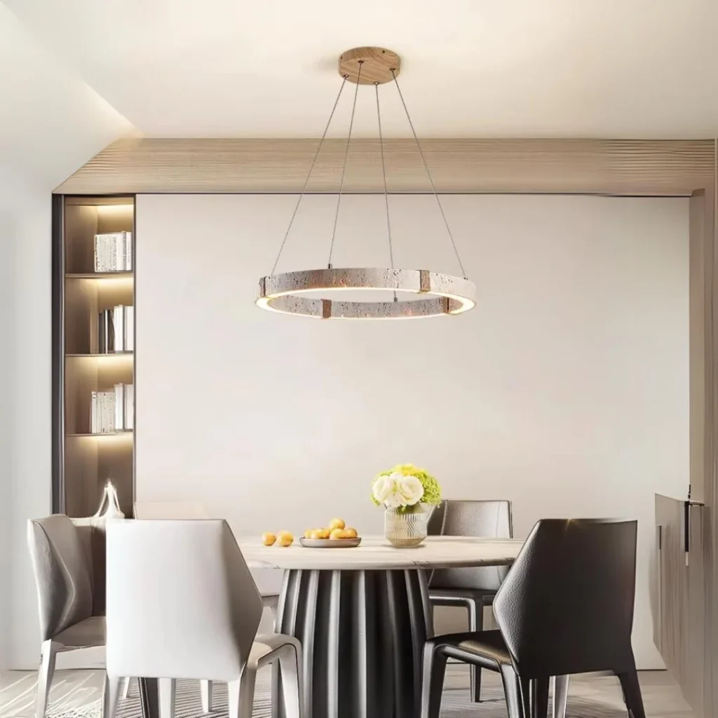 Vouvray Round Chandelier with suspended circular LED ring and textured finish, illuminating a modern dining room interior