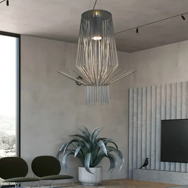 A striking, inverted conical Allegretto Assai Suspension lamp made of thin metal rods hangs over a large potted plant and a modern sitting area.