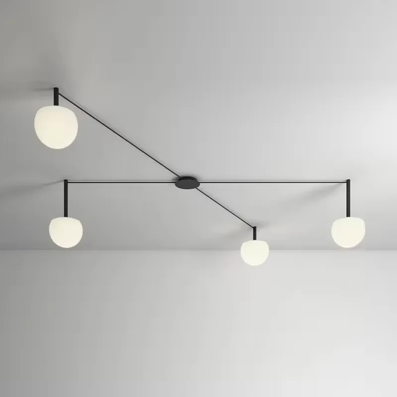 Minimalist Circ LED Semi-Flushmount with long, thin black arms and glowing white globe shades spread across a modern ceiling.
