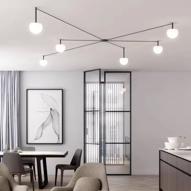 Minimalist Circ LED Semi-Flushmount with long, thin black arms and glowing white globe shades spread across a modern ceiling.