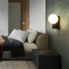 Nordic Dimmable LED Wall Lamp with a round, soft glow design, enhancing the cozy ambiance of a contemporary bedroom.